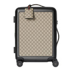 Luggage with Gucci pattern on a light gray background