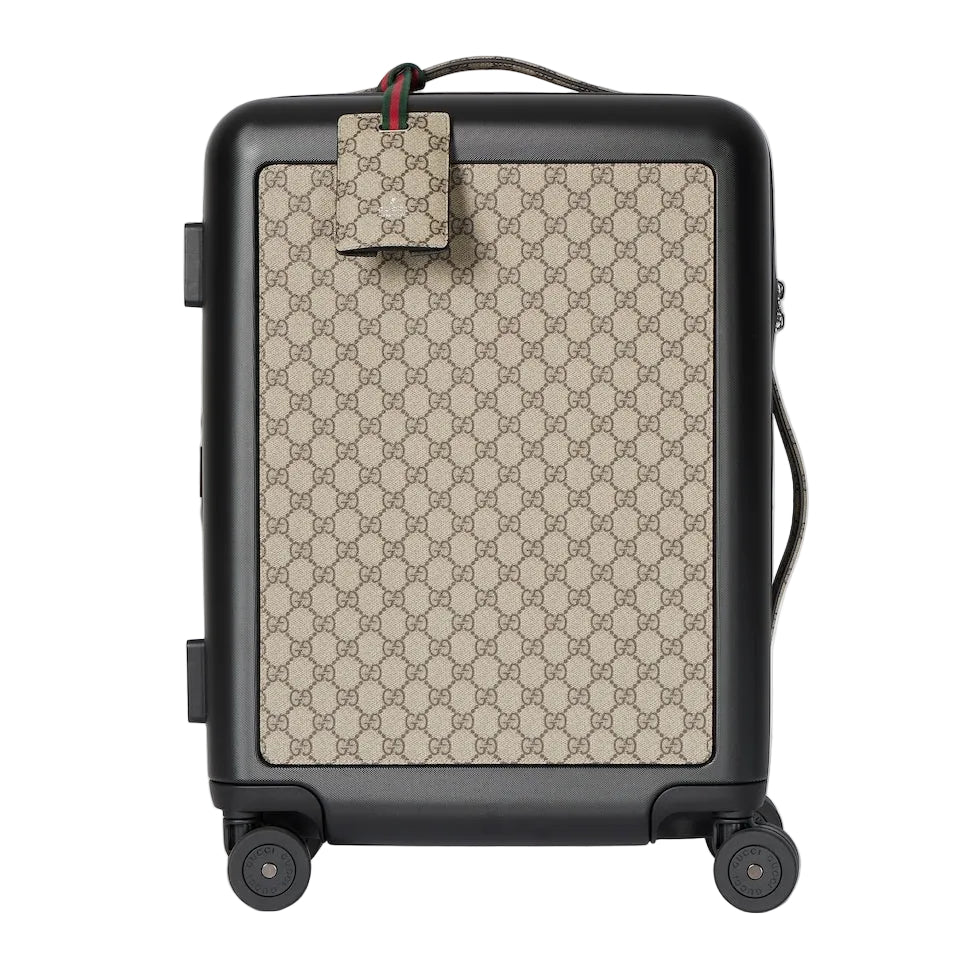 Luggage with Gucci pattern on a light gray background