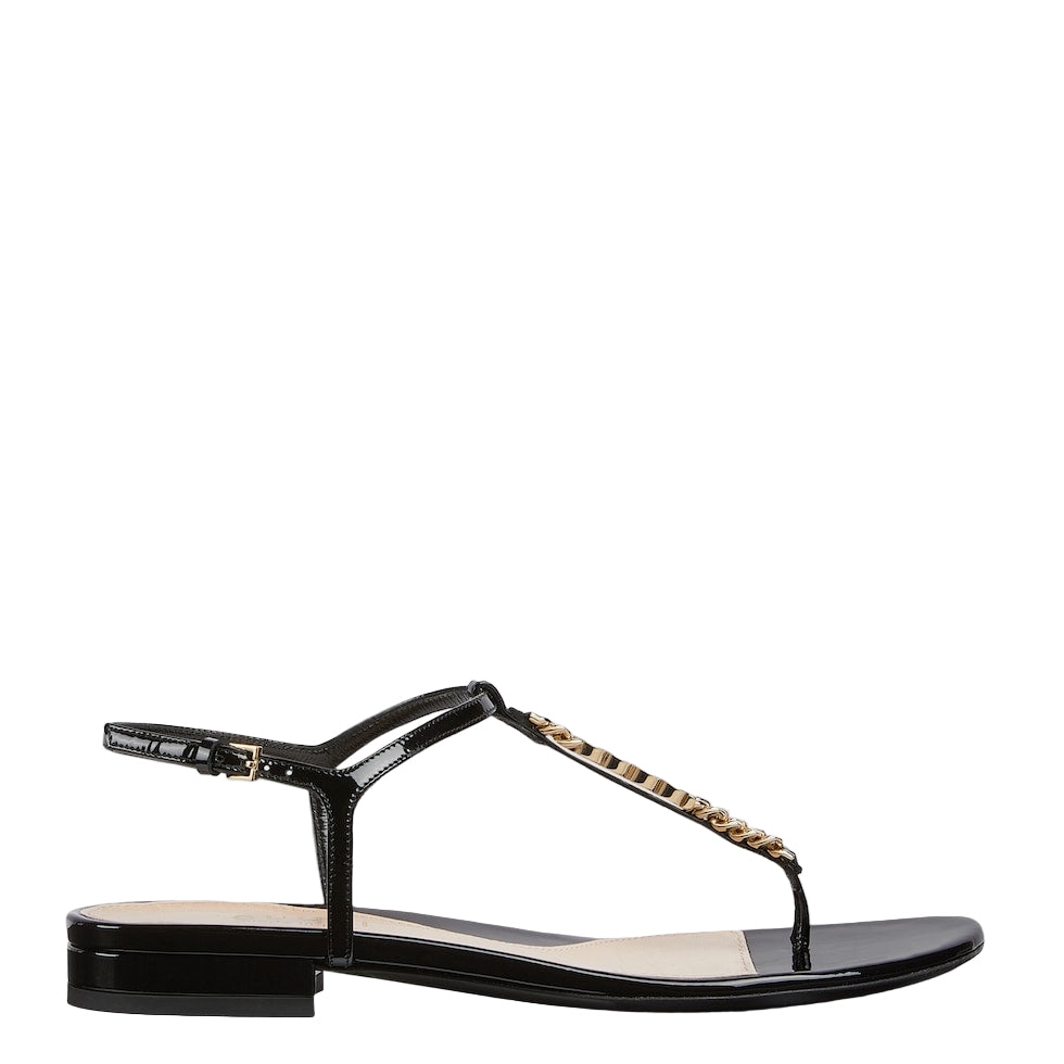 Black Gucci sandal with gold chain detail on a white background