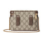 Designer handbag with chain strap on a light gray background
