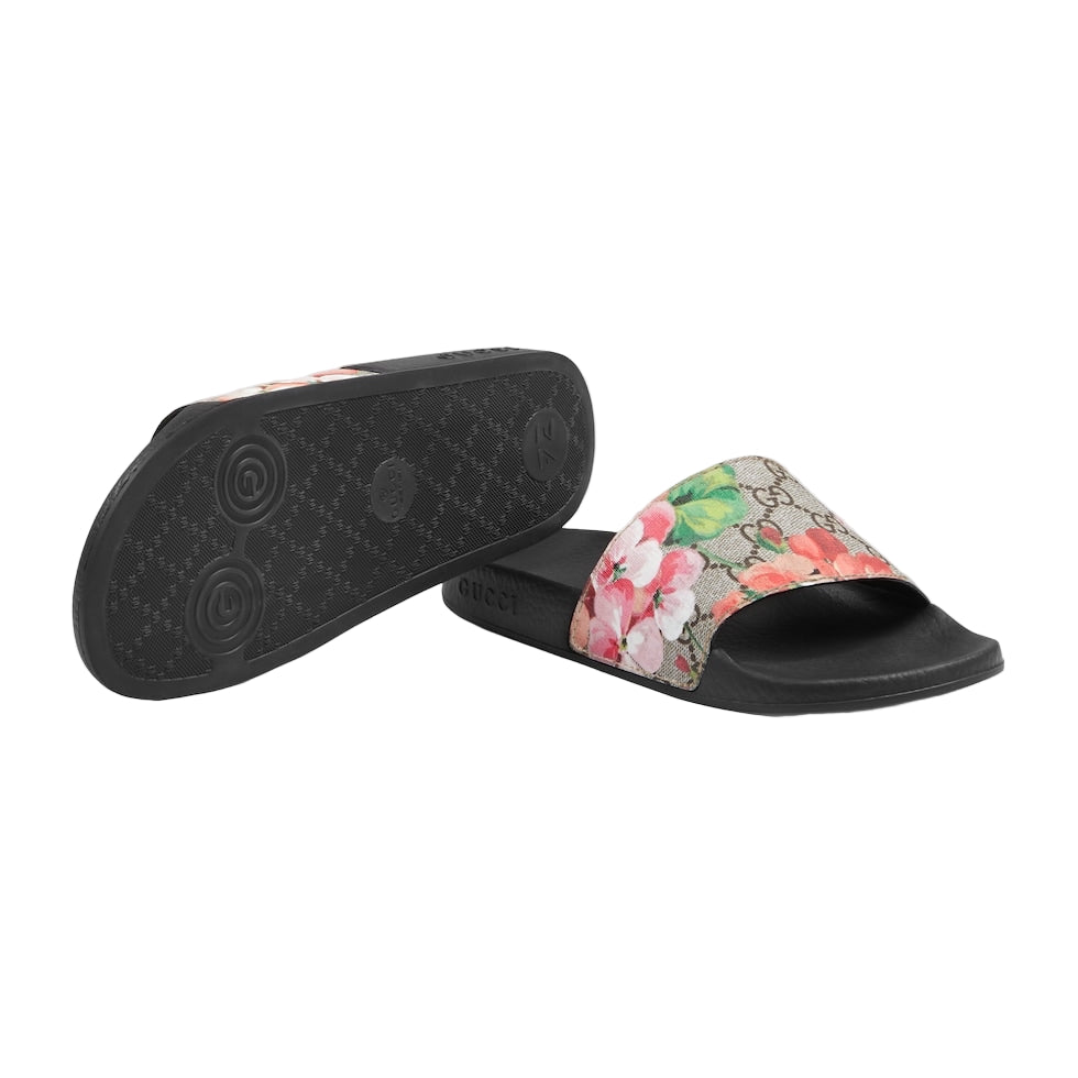 Floral slide sandal with black sole on a light gray background