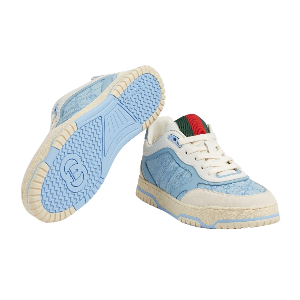 Light blue and beige sneaker with a brand logo on a light gray background