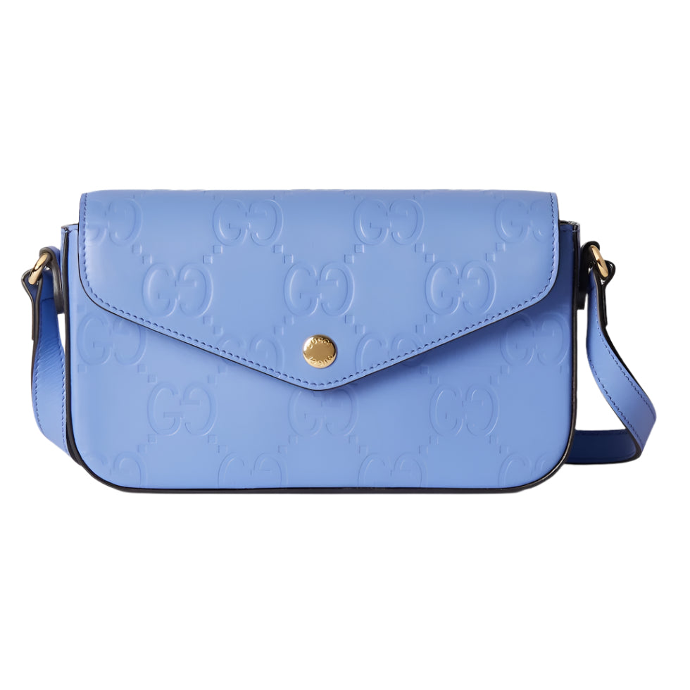Blue handbag with gold accents on a light gray background