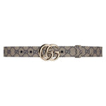 Gucci belt with double G buckle on a light gray background