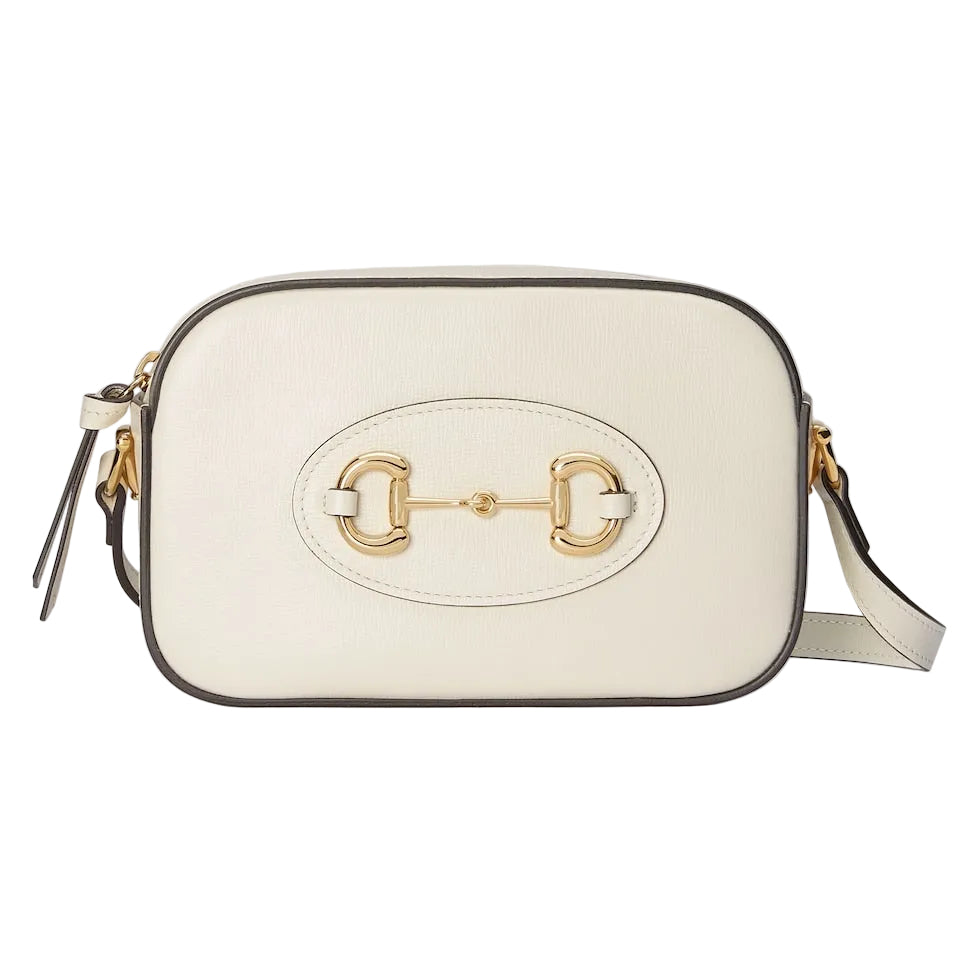 White handbag with gold emblem on a light gray background