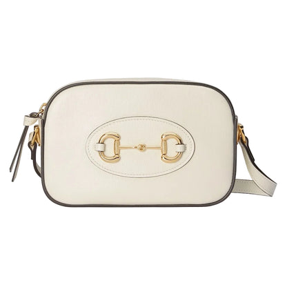 White handbag with gold emblem on a light gray background