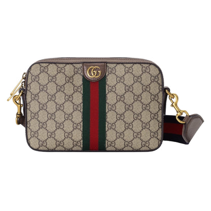 Designer handbag with monogram pattern and red stripe on a light gray background