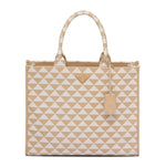 Prada tote bag featuring a beige and white geometric triangle pattern, with a small gold-tone Prada logo plaque on the front and a matching leather hangtag.