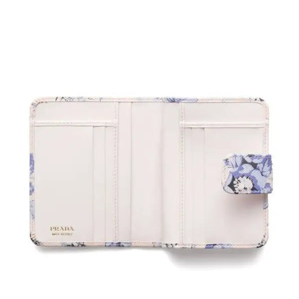 Prada wallet with floral design on a white background