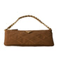 Brown quilted handbag with gold chain handle on a white background