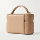 Beige quilted vanity bag with 'Saint Laurent' branding on a white background