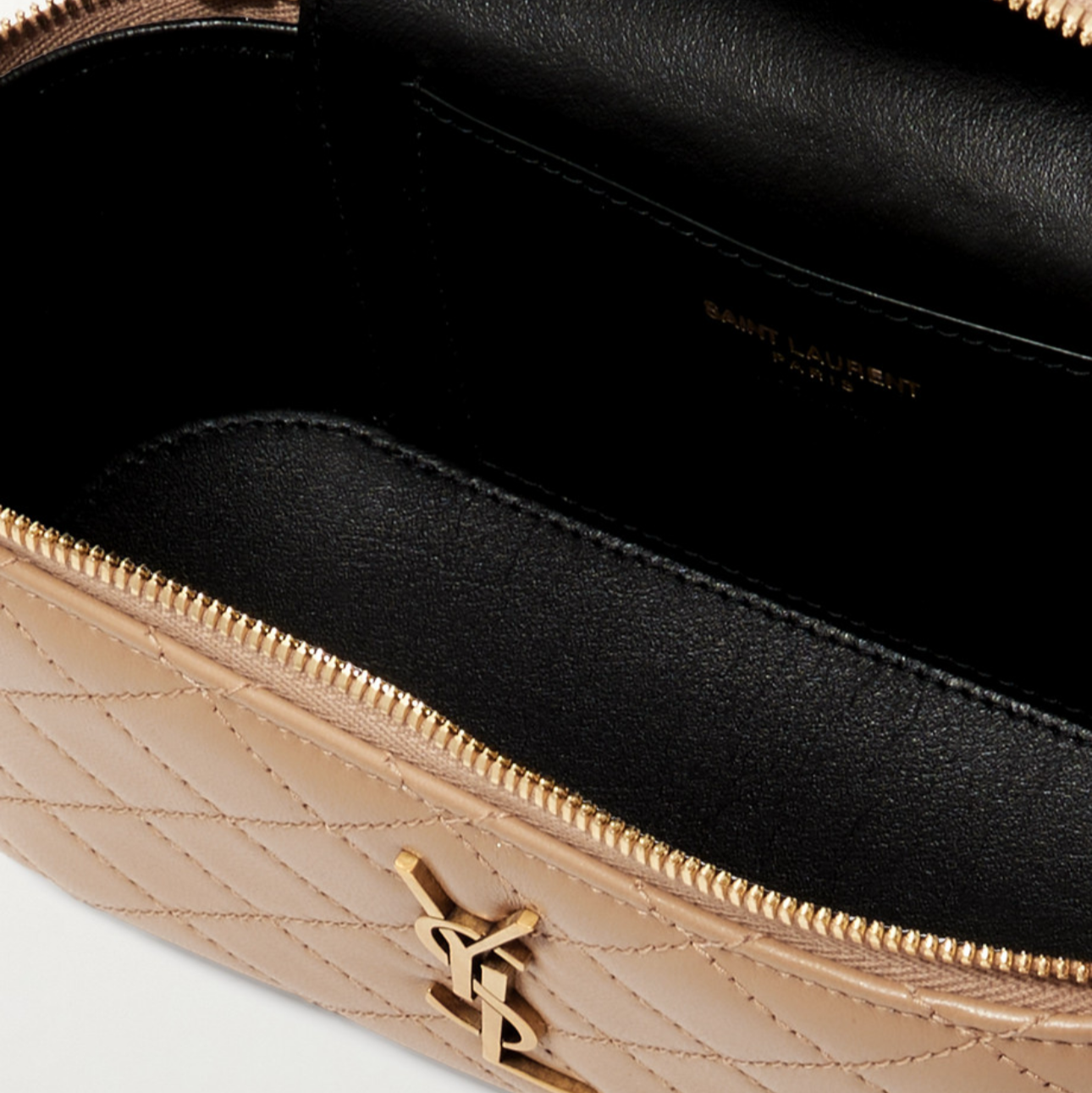 Saint Laurent vanity leather shoulder bag with open zipper showing interior.