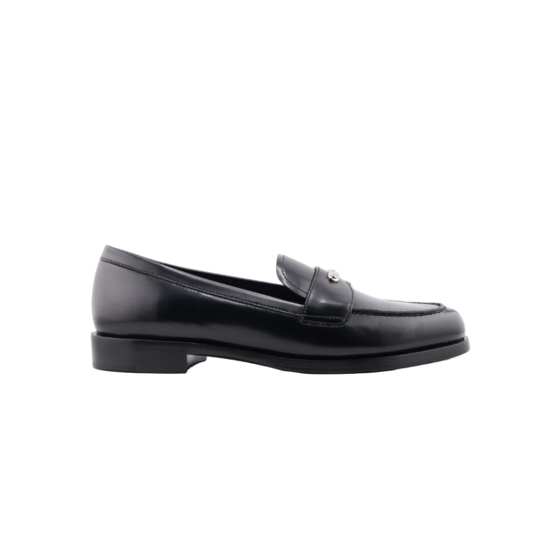 Black Prada loafer shoe on a white background
