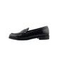 Black loafer shoe on a white cushioned surface