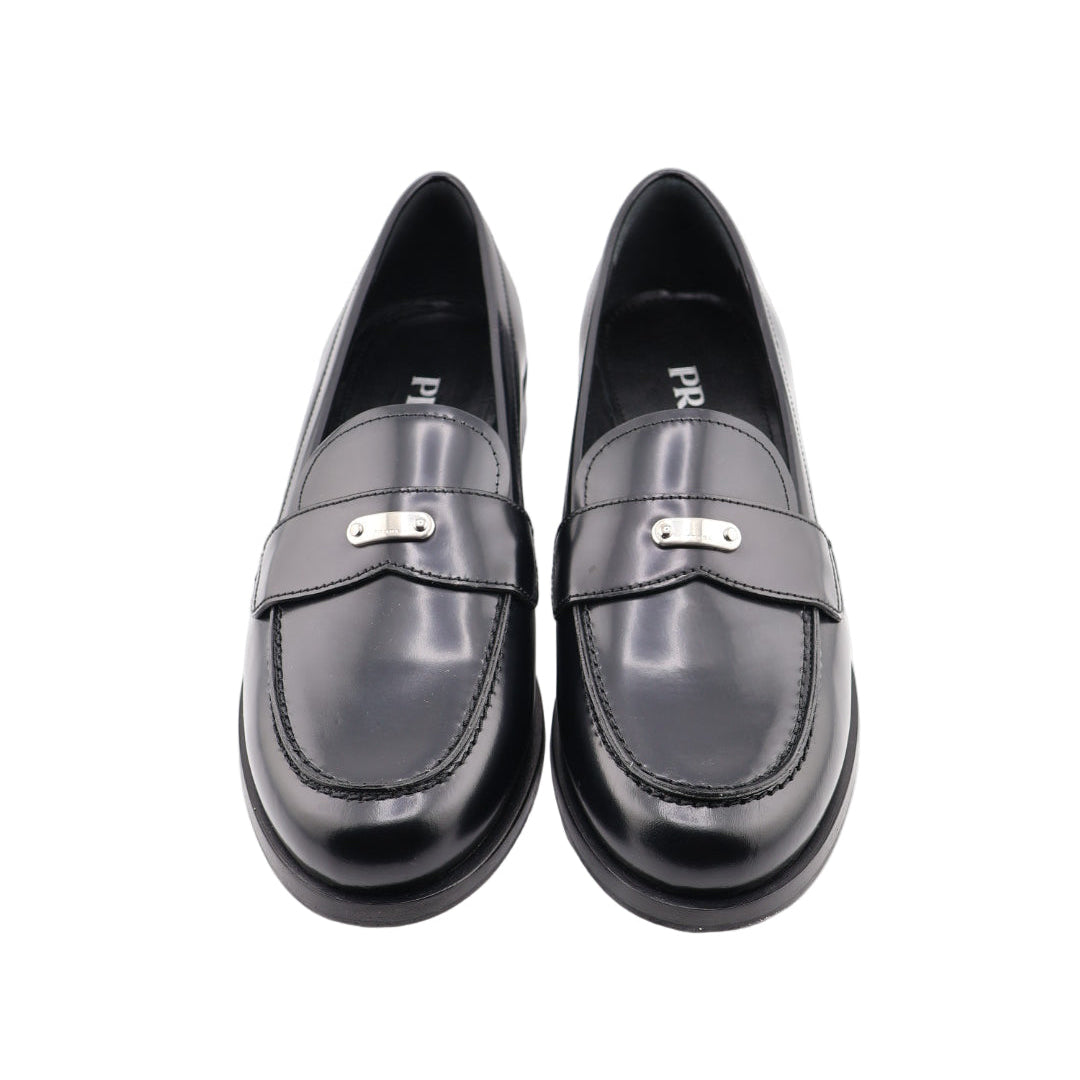 Pair of black loafers on a white background