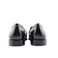 Pair of black dress shoes on a white background