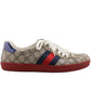 Sneaker with Gucci logo and red, blue, and white stripes on a white background