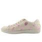 Beige sneakers with pink floral patterns on a white background