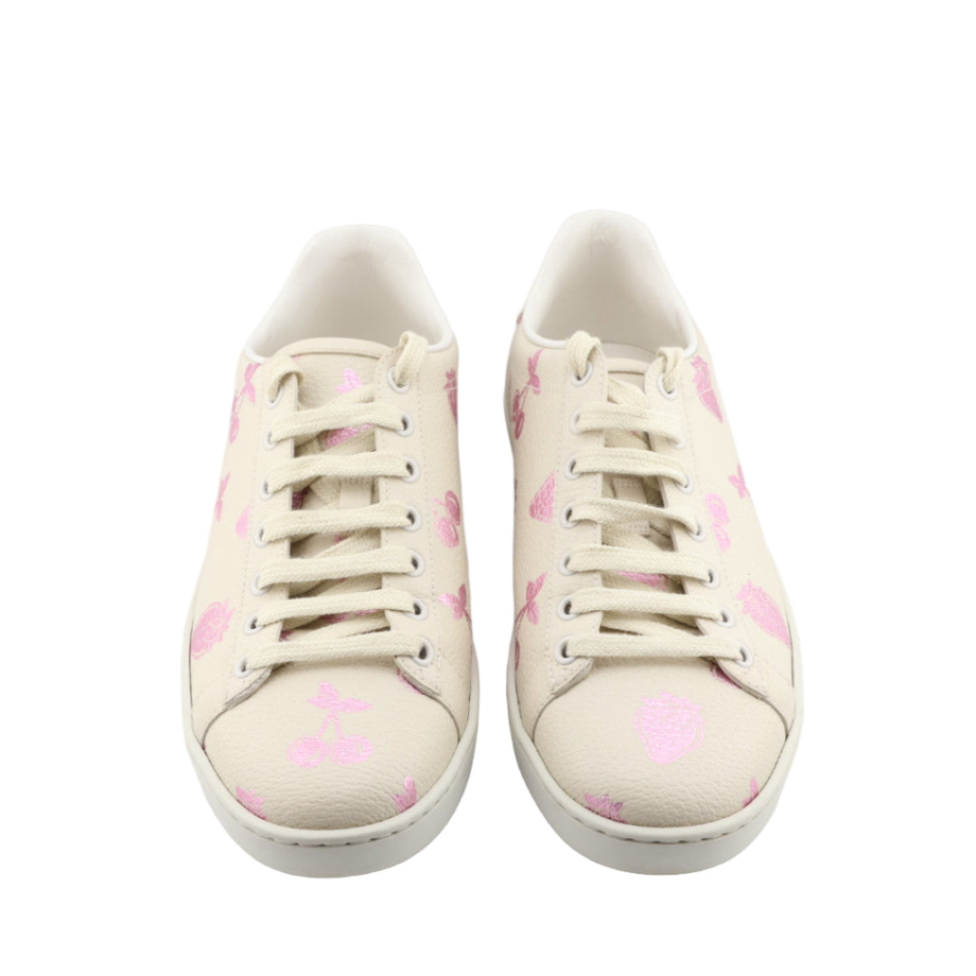Pair of white sneakers with pink floral pattern on a white background
