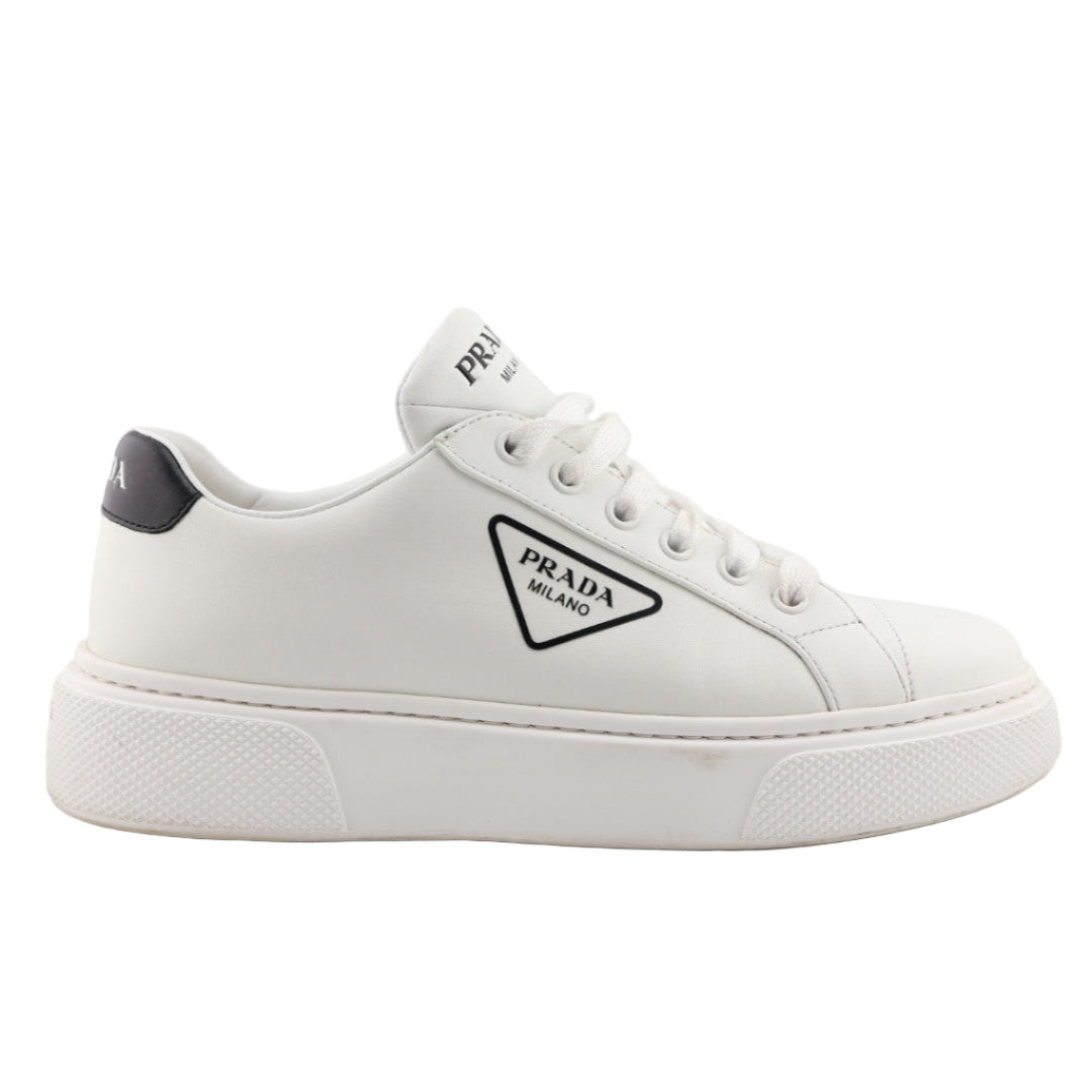 White sneaker with Prada logo on a white background