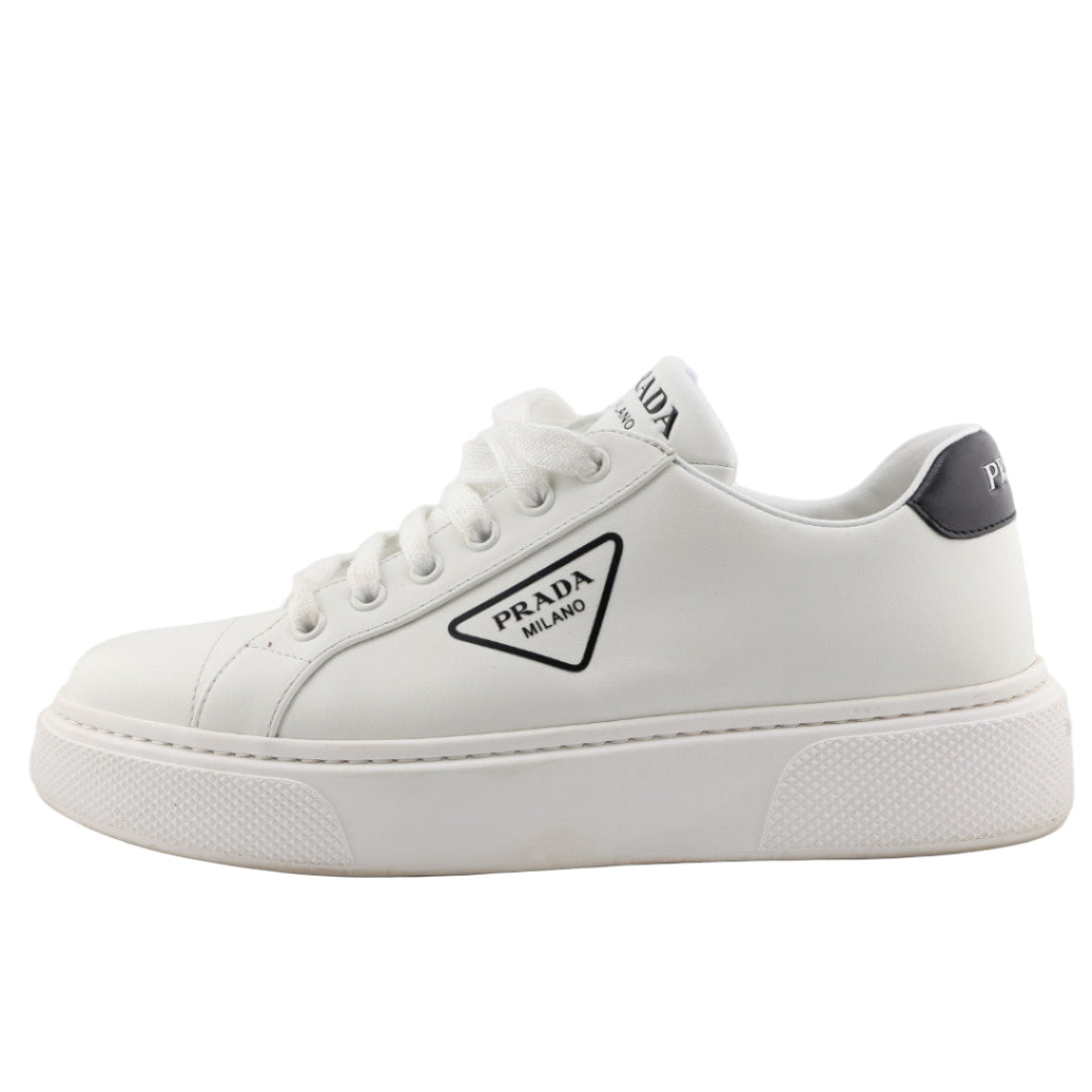 White sneaker with Prada logo on a white background
