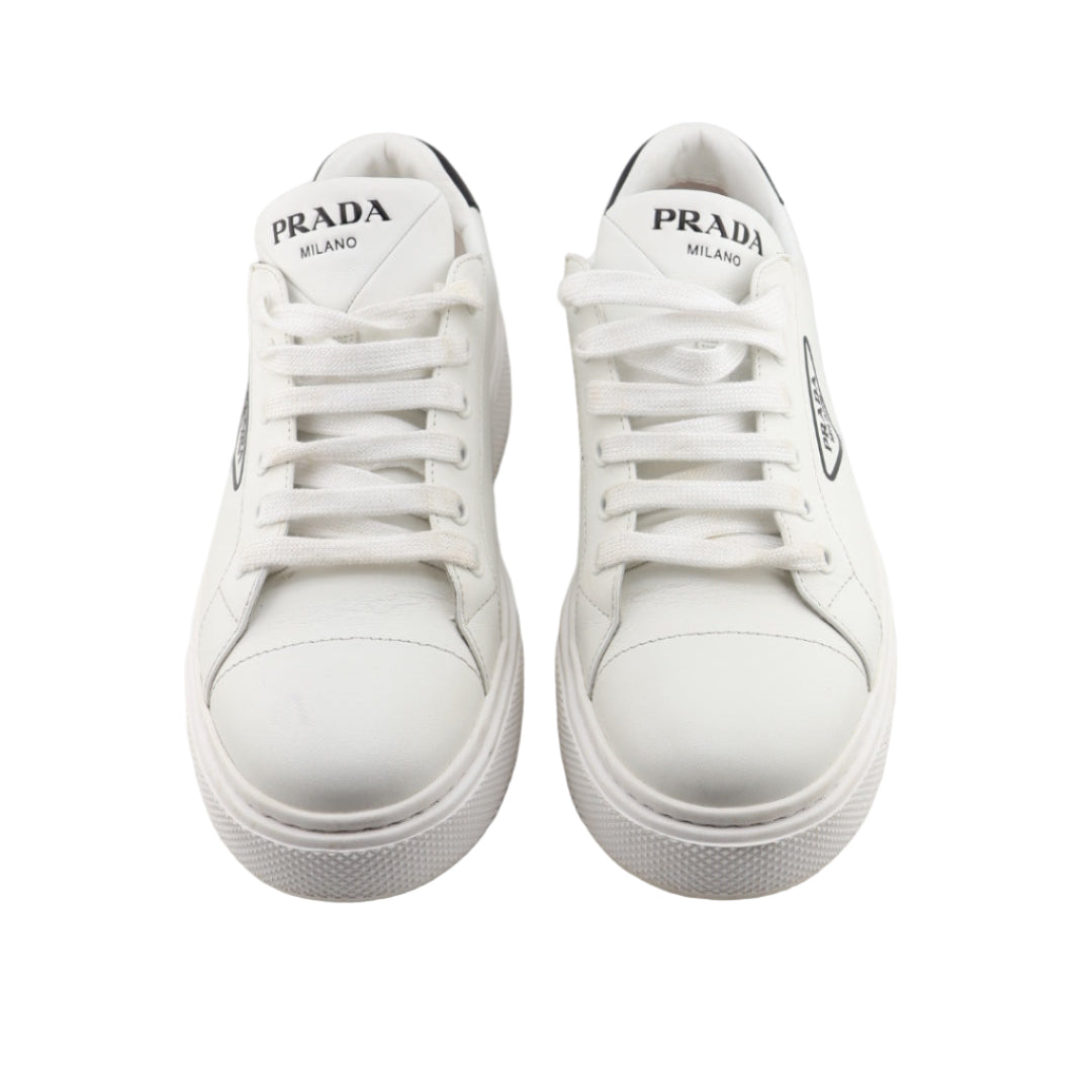White sneakers with Prada logo on a white background