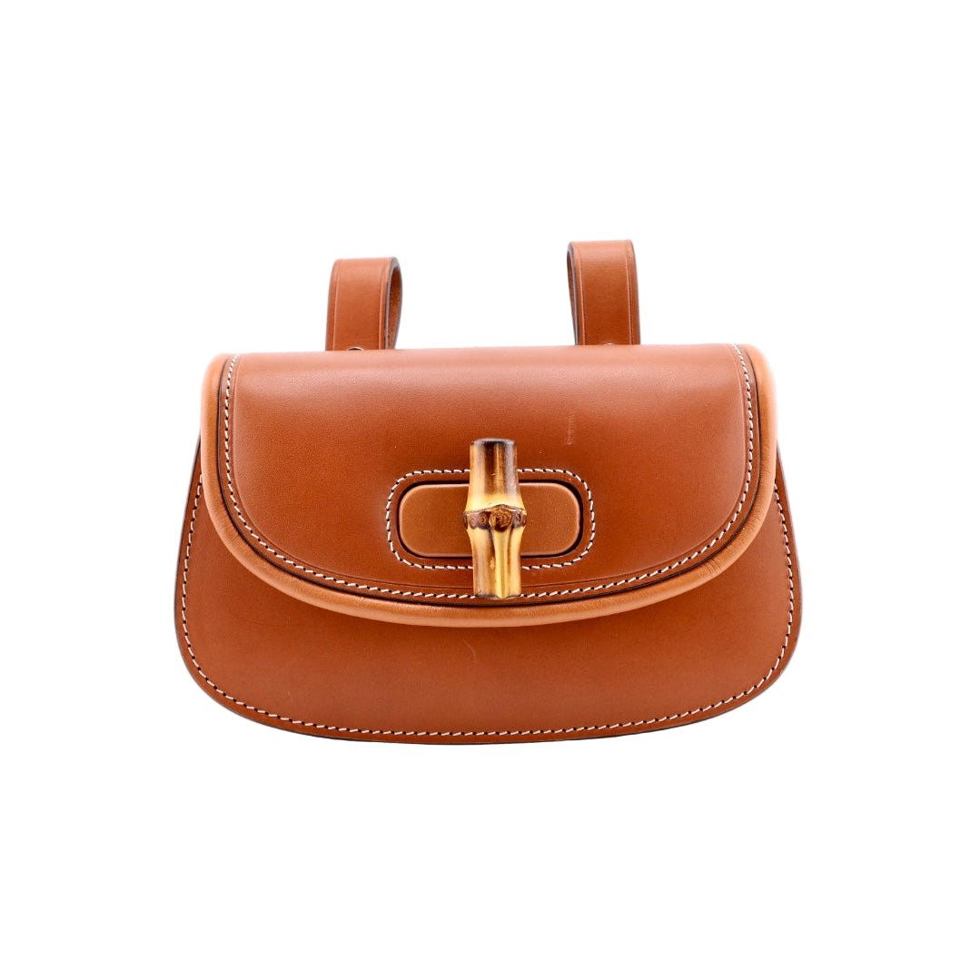 Brown leather handbag with gold clasp on a white background