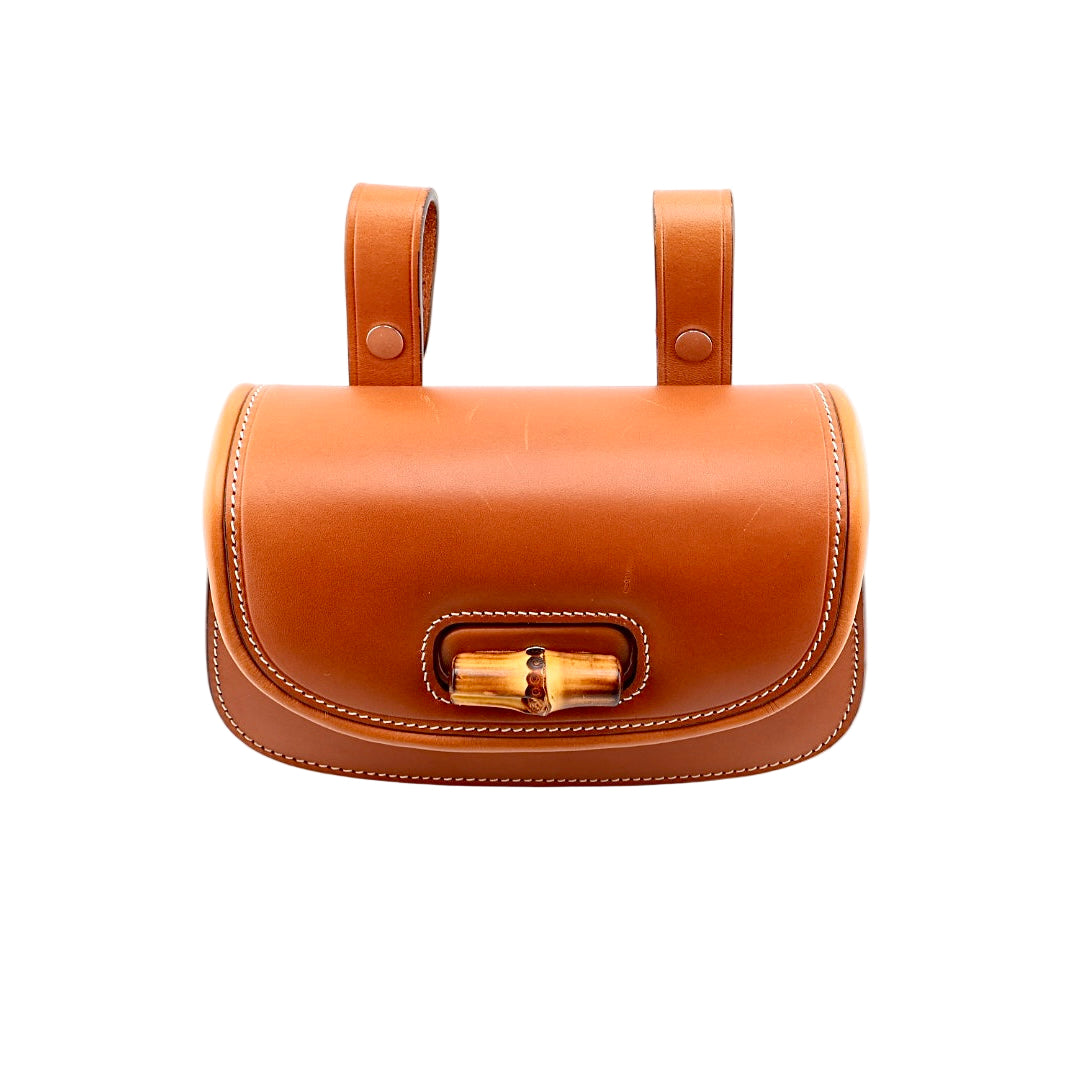 Brown leather handbag with gold clasp on a white background