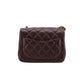 Brown quilted handbag on a white background