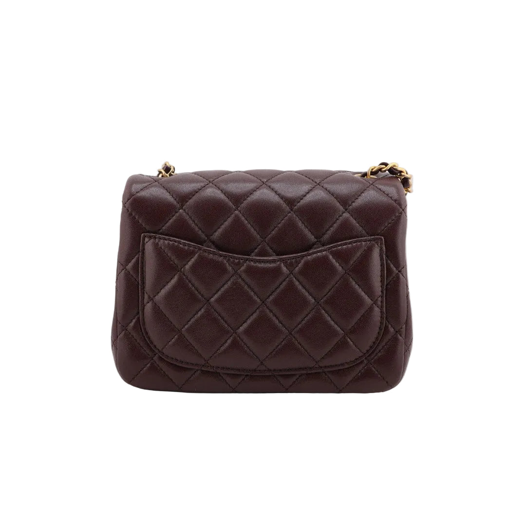 Brown quilted handbag on a white background