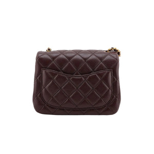 Brown quilted handbag on a white background