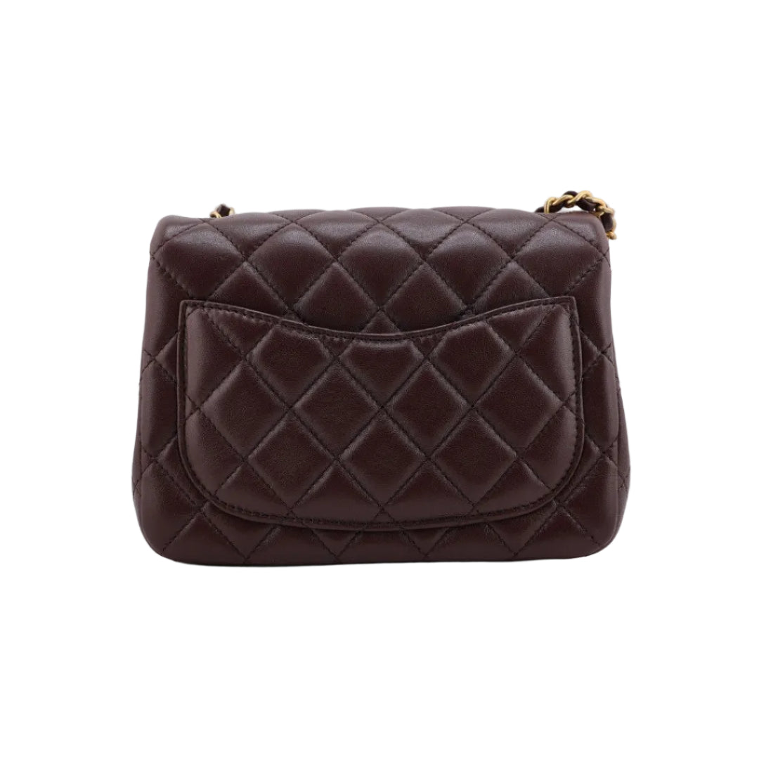 Quilted brown handbag on a white background