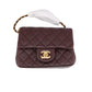 Brown quilted handbag with gold hardware on a white background