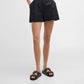 Person wearing black shorts on a white background
