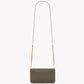Green crossbody bag with a strap on a white background