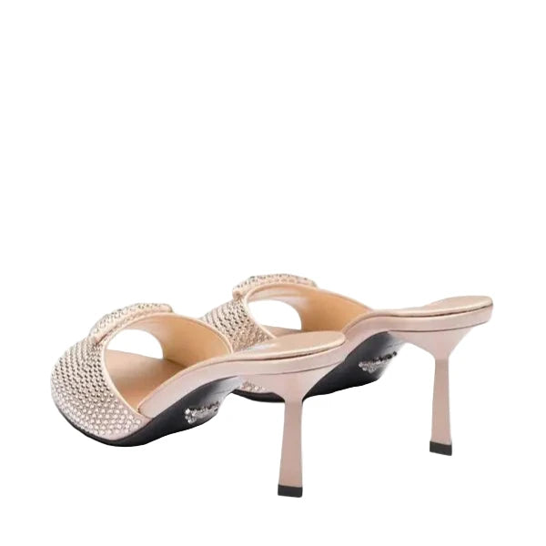 Pair of high-heeled shoes with embellishments on a white background