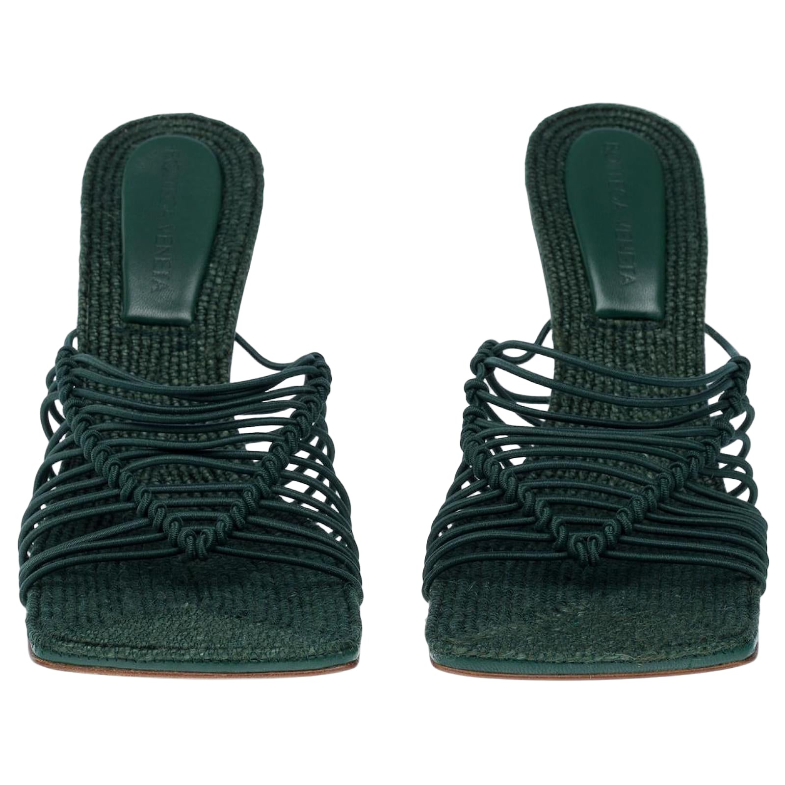 Pair of green woven sandals on a white background
