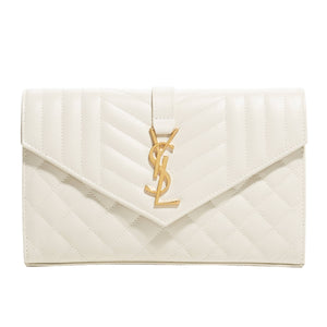 White envelope clutch with gold YSL logo on a light gray background