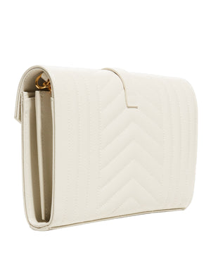 White quilted clutch bag on a light gray background