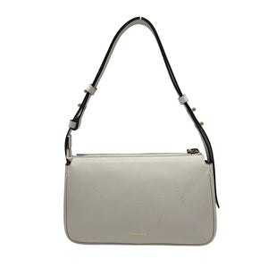 Light gray handbag with a black strap on a white background