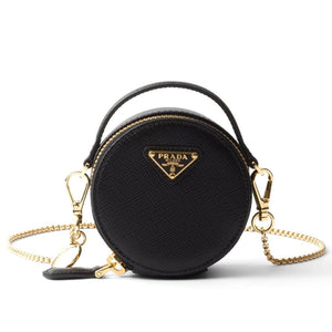 Black Prada handbag with gold chain on a white background