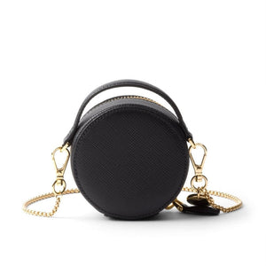 Black round handbag with gold chain on a white background