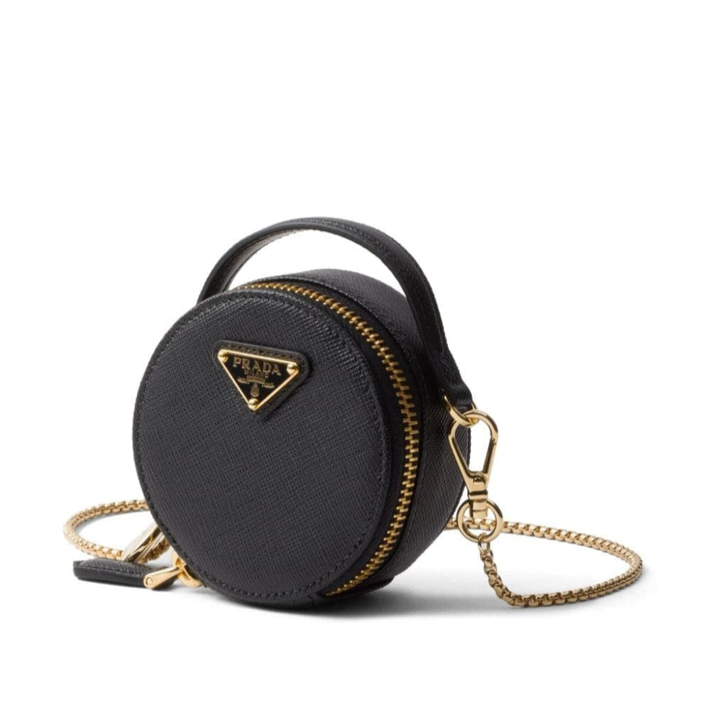 Black round handbag with gold chain and Prada logo on a white background