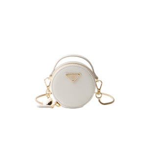 White round handbag with gold accents on a light gray background