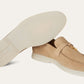 Beige loafer shoe with a white insole on a light gray background