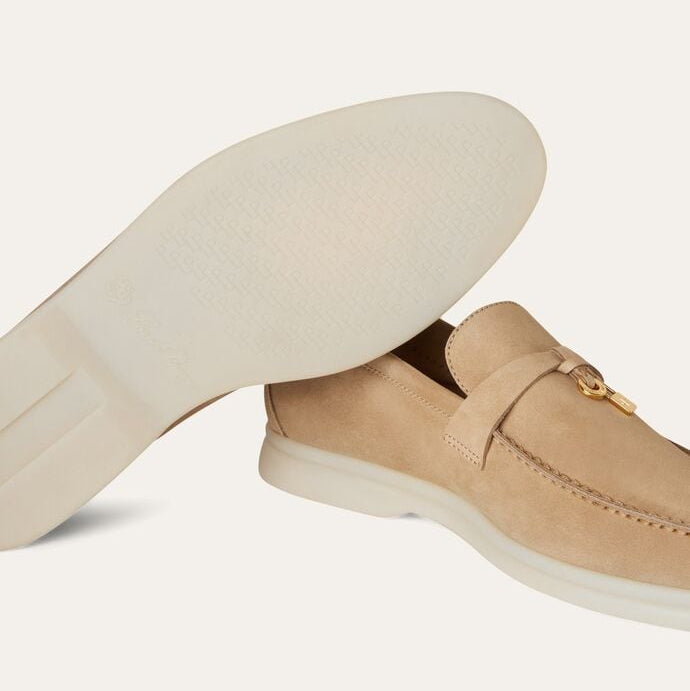 Beige loafer shoe with a white insole on a light gray background