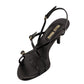 Black sandal with thin straps on a white background
