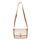 White handbag with brown leather accents on a white background