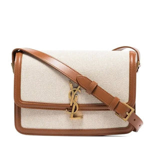 Designer handbag with brown strap and visible logo on a white background