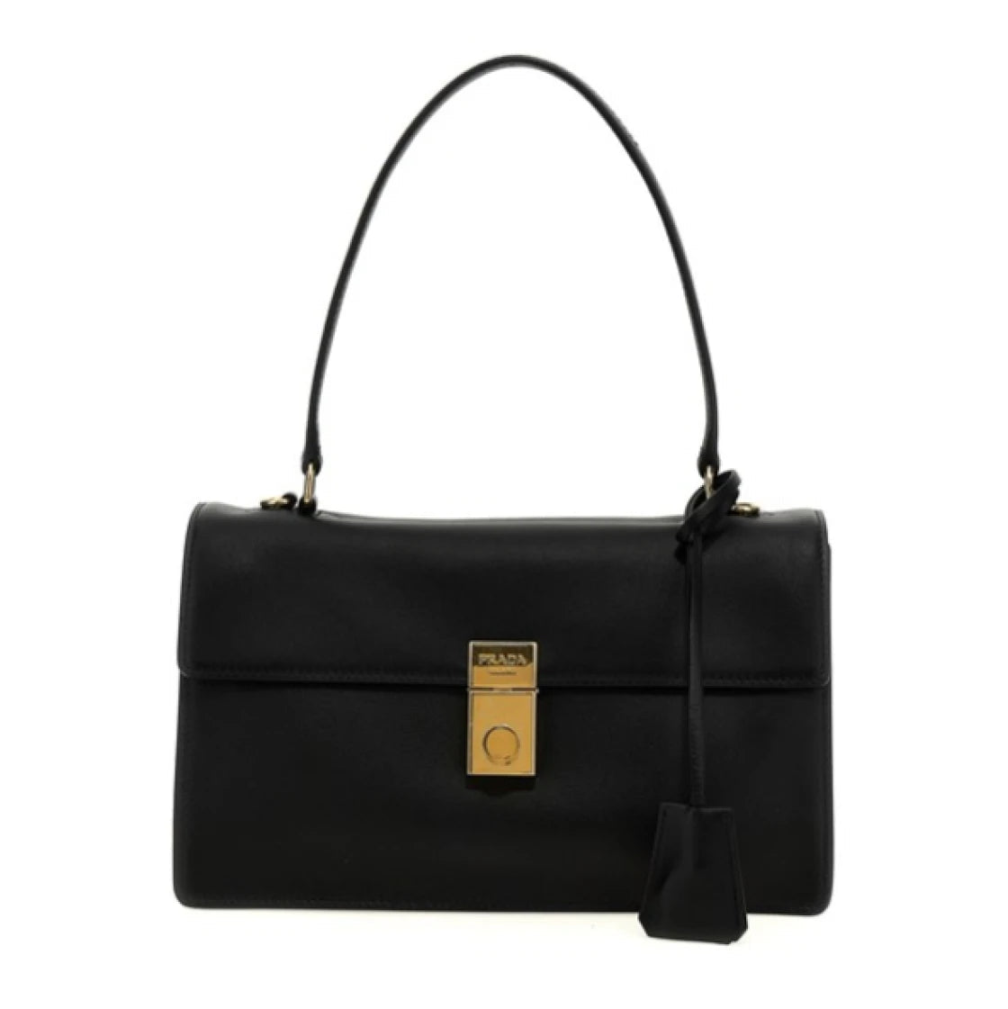A black leather handbag with a structured rectangular shape, a single top handle, a front flap, and a gold-tone lock closure. A black leather tag hangs from the side, and the bag is photographed against a plain white background.